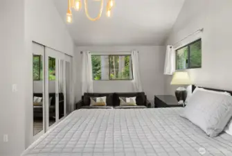 Main floor primary boasts a large area for a private sitting room