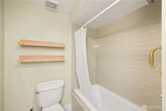 Deep soaking tub and tiled shower.