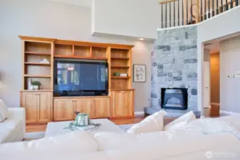 Cozy Stone Fire Place, above is the Walkway to Primary Bedroom.