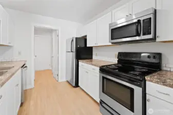 galley kitchen leads to laundry room and door to back yard
