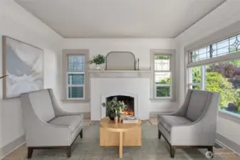 Cozy sitting room located just off of the living room with original fireplace