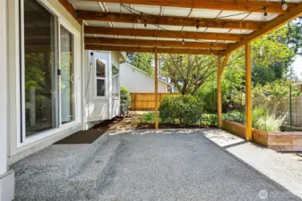 Large lot with fully-fenced backyard with covered patio and garden spaces