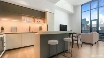 Open space with island kitchen adjacent to livin/dining