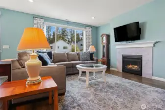 Main floor great room with a formal living room featuring a gas fireplace opens to the kitchen and dining room with sliding door to the back deck with Cascade Mountain views and southern exposure.