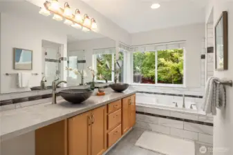 The private en suite is a true 5 piece with soaking tub, custom tiled shower and 2 vessel sinks. The water closet is around the corner to the right.