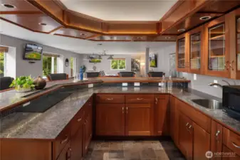 Custom cabinetry with granite counters and tiled floors as well as glass upper cabinets.