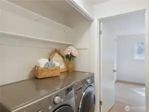 Newer full-sized washer & dryer in unit with extra storage.