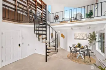 Spiral staircase up to the loft with floor to ceiling bookcase!