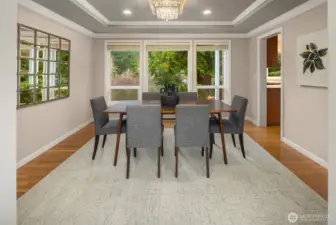 This lovely dining room has hardwood floors, in-laid ceiling, and big windows looking out to the lake!  The door to the right side goes into the kitchen.