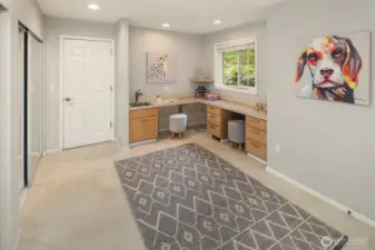 The Bonus Room as you come in from the garage. A perfect 2nd office area w/ built in desks, craft room, or mud room. Lots of storage closets to the left side with mirrored slider doors, plus another big closet to the right side  which is out of this photo.