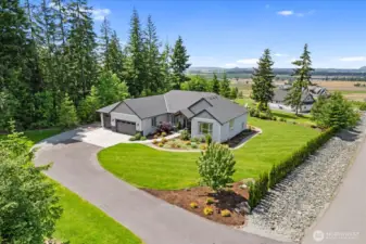 Professionally landscaped yard. This home  has beautiful views and privacy with the  creek on one side and green space on  another.