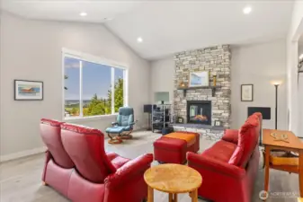Beautiful floor to ceiling stone gas fireplace.