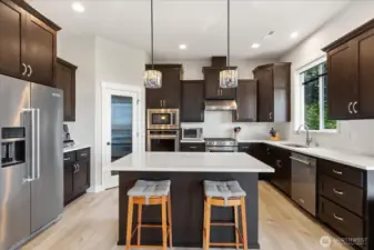 Stunning kitchen with KitchenAid appliances,  pantry and convenient island for your  morning coffee.