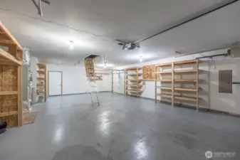 This large garage provides shelves for storage, access to the attic and backyard. Equipped with a 3rd garage door for the "Project!"