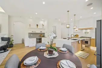 Open-concept living showcases refined sophistication—seamless transitions between dining and lounge under soaring 10' ceilings. Perfect for gatherings and everyday elegance