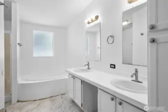 Conveniently located 5 piece primary bathroom features a frosted window for privacy.