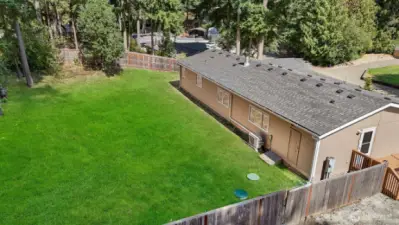 The backyard has the perfect combination of privacy and space for sunshine. Lawn has been edited for photography purposes.