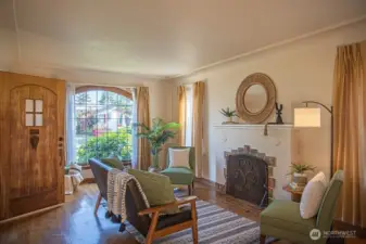 Spacious living room with tons of natural light and original fireplace and sreen