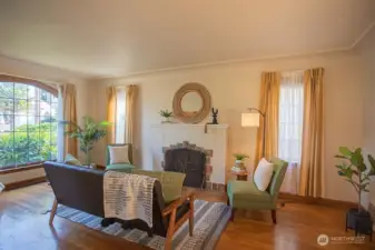 Spacious living room with tons of natural light and original fireplace and screen