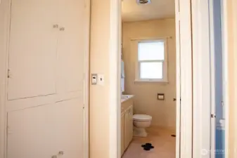 Hallway storage with bathroom beyond