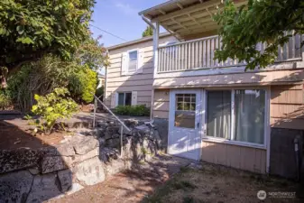 backyard with entry to lower floor bonus room
