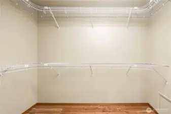 Primary bedroom walk in closet