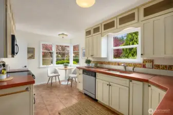 Eat-in kitchen with large windows.