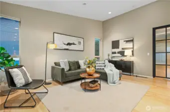 The living room has ample space for a large sofa, a couple of chairs and a side board. The vaulted ceiling adds to the spacious feel of this room and the drama of the setting.