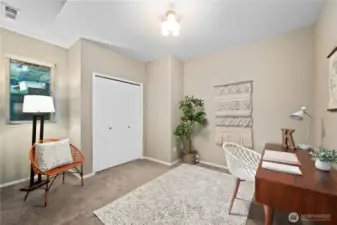 This bedroom features a double closet and is shown here as a home office.