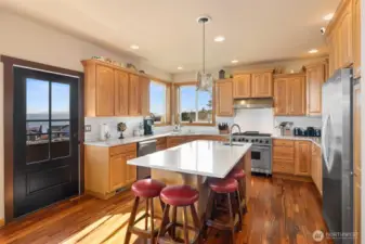 Open kitchen with breakfast bar, SS appliances, and stunning views