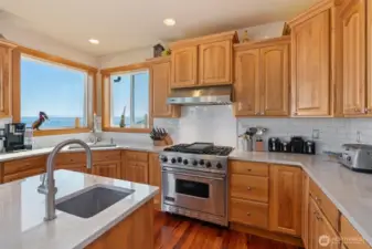 Viking gas range and hickory cabinets