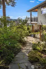 The lower level deck leads to beautiful, lush landscaping, a greenhouse, raised beds, garden shed and covered storage ~ certain to inspire any green thumb, lawn space great for pets & play that completes a serene and usable outdoor space.