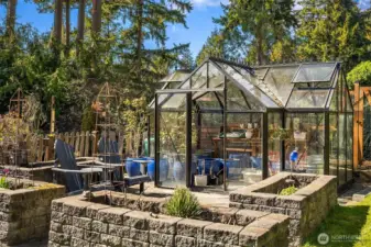 The lower level deck leads to beautiful, lush landscaping, a greenhouse, raised beds, garden shed and covered storage ~ certain to inspire any green thumb, lawn space great for pets & play that completes a serene and usable outdoor space.