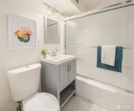 Full bathroom located just off the kitchen with stylish white tile.