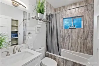 The full bath on the 2nd floor is outstanding. Ceramic tile floors, plenty of storage, and a jetted tub are the highlights of the room. The cool light fixtures brighten the room and an overhead towel rack is perfect for extra towels.