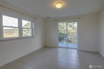 Lower unit guest bedroom with walk out. This wrap around deck connects you to the oceanside deck with hot tub.