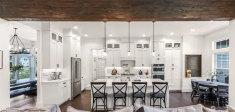 Kitchen with quartz counters, soft close cabinets and spacious island, breakfast nook and access to pantry, laundry and garage.