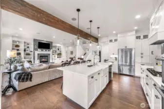 Another view of kitchen into great room. Kitchen with farm sink, natural gas cook top and hood. This kitchen will please the cooks in the group.