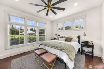 Primary suite with lots of natural light. Look at the beautiful ceiling fan.