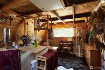 Interior with sink and counter space, looking through to cozy living space.