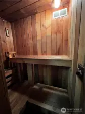 Immaculate cedar sauna within garage storage room