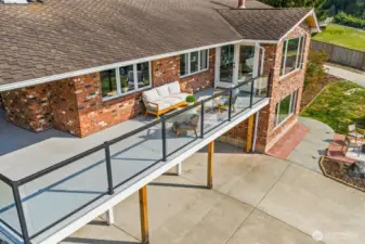 large deck wraps around and has access from the home on both ends