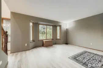 Loads of light flood into this beautiful living room complete with new flooring.
