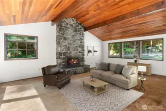 The floor-to-ceiling Mats Mats Bay quarry rock fireplace anchors the living area on the main floor.