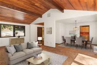 A view of the main living room, looking into the den on the right, and te front door in the LH background.