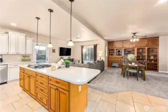 The inviting kitchen opens to the family room and additional dining or expanded family room space, offering a flexible, open layout ideal for living and entertaining.