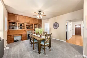 This versatile flex space, adjacent to the kitchen and family room, can serve as extra dining, a cozy sitting area, or expanded family room, complete with built-in cabinetry and an electric fireplace.