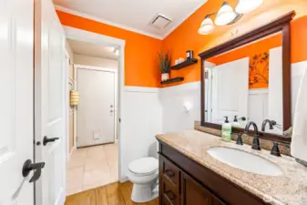 Convenient main-floor powder room, accessible from both the main hall and utility room.