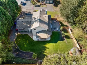 Aerial perspective showcases the rear yard of this generous .37-acre lot with abundant space for play, parties, pets, and more.