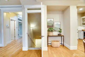 Notice the transom window above the doorway leading to the stairs that take you down to the finished basement and the roomy three-plus car garage. The nook to the right would be an ideal spot for a small desk, perfect for meal planning.